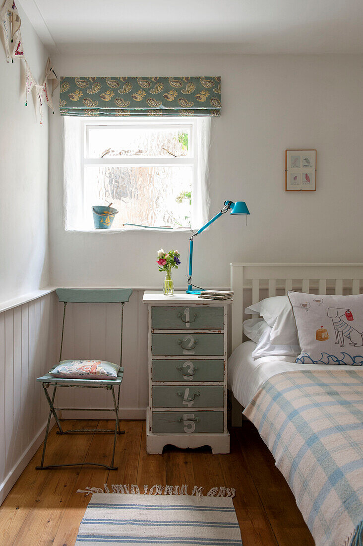 Painted side drawers below window in single bedroom Cornwall UK