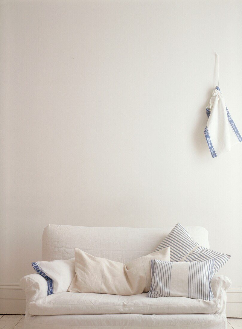 Budget Style living room close up with recovered sofa and recycled linen tea towel cushions