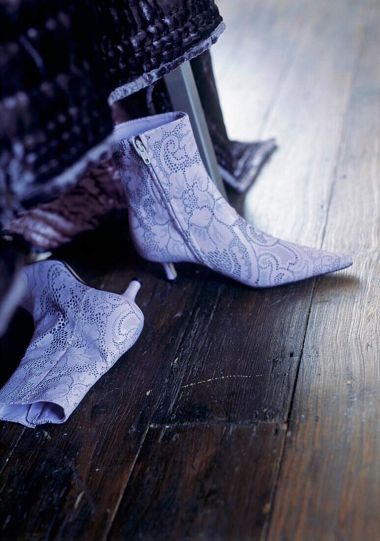 Floral ankle boots on wooden floor