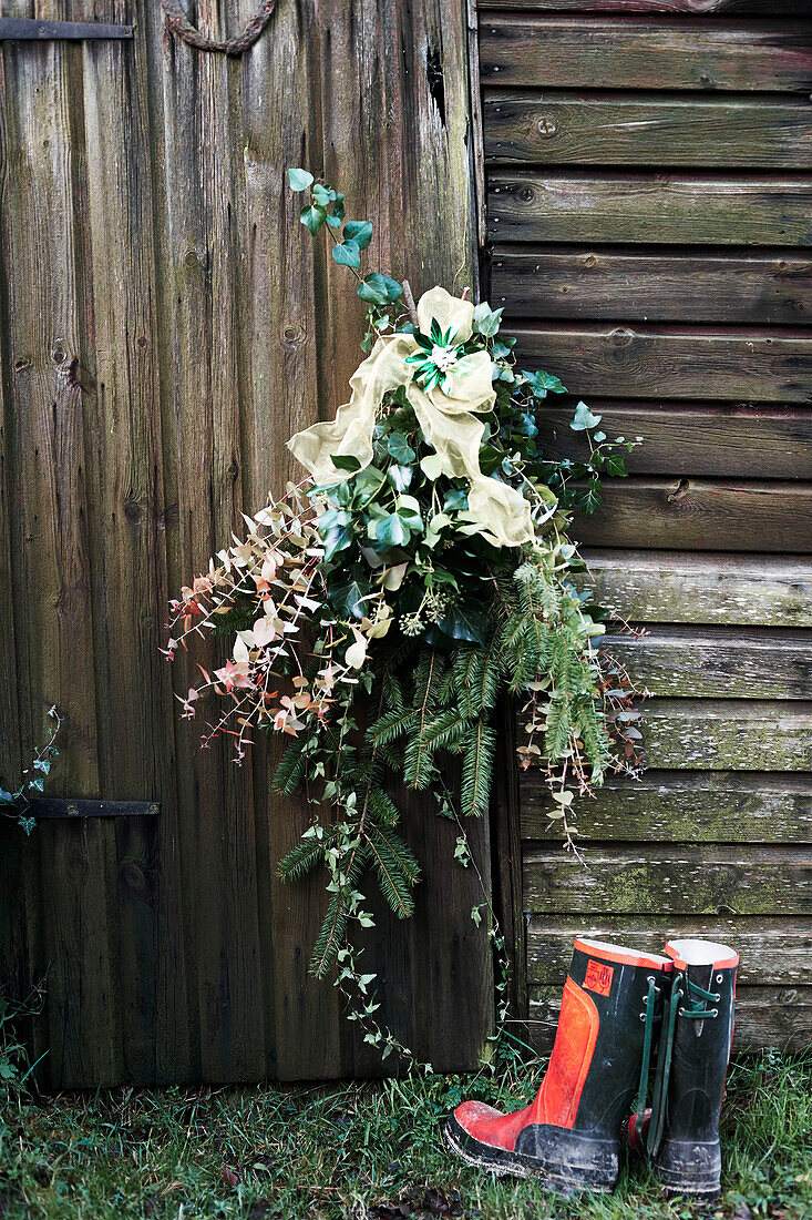 Garland of winter Evergreens tied to wooden door exterior Shropshire England UK