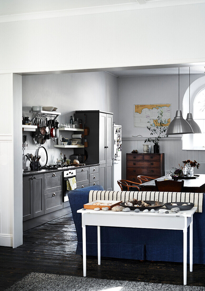 Open plan grey fitted kitchen in Lyme Regis home Dorset UK