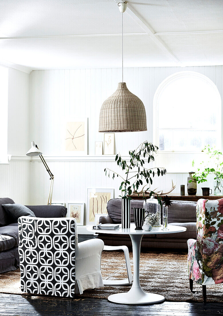 Wicker pendant shade in living room with black and white upholstered armchair in Lyme Regis home Dorset UK