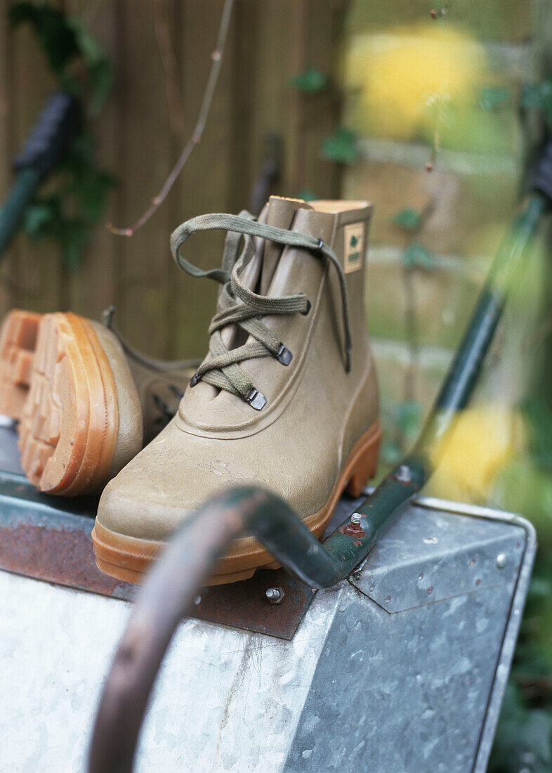 Boots on wheel-barrow close-up