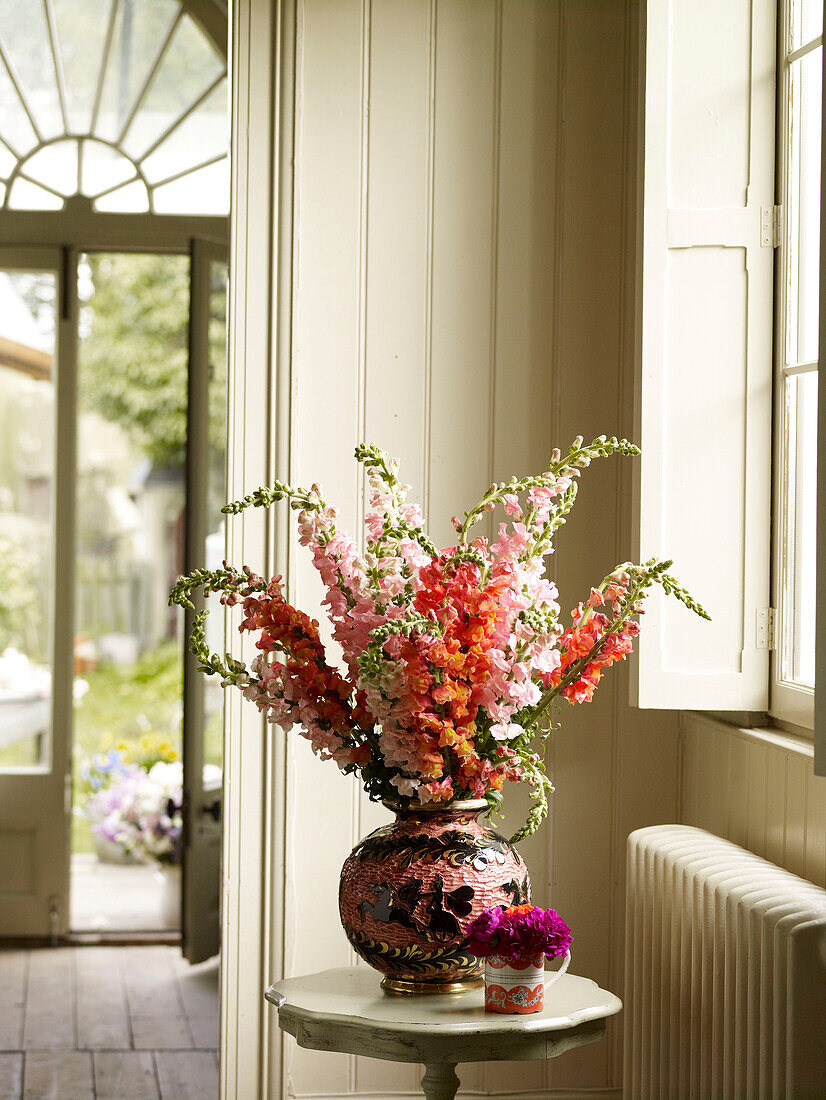 Flowers on side table in entrance hall