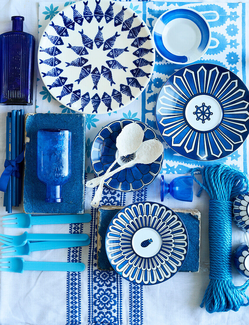 Blue and white plates on patterned tablecloth in Greek villa