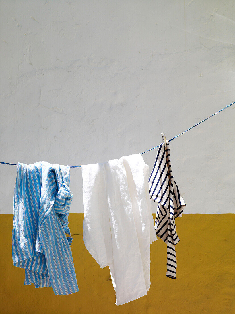 Clothing hangs on courtyard washing line Spain