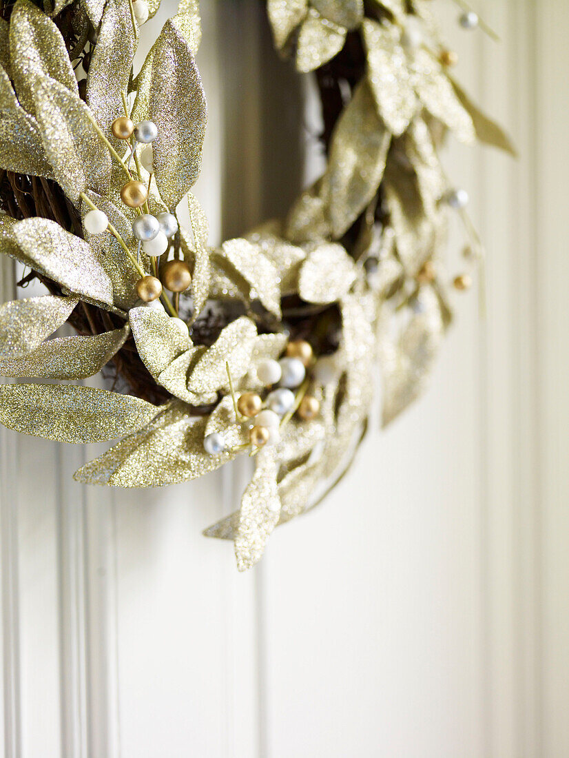 Christmas wreath with gold leaves and mistletoe berries