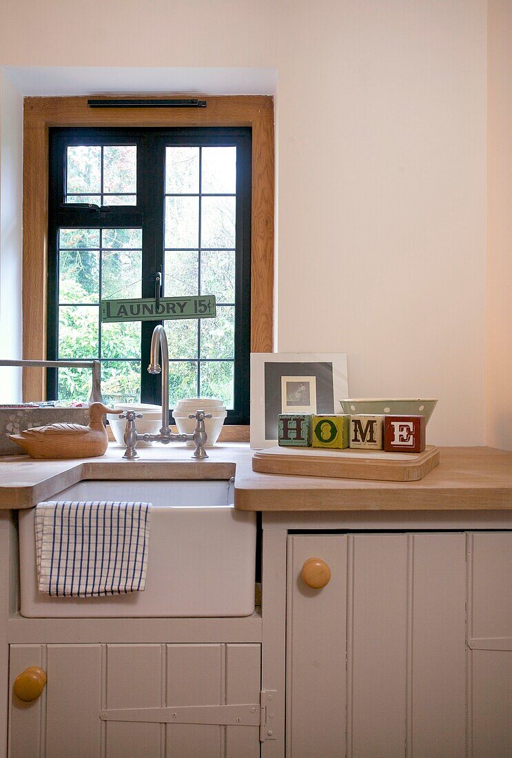 Single word 'home' on kitchen counter under window of Cranbrook family home, Kent, England, UK