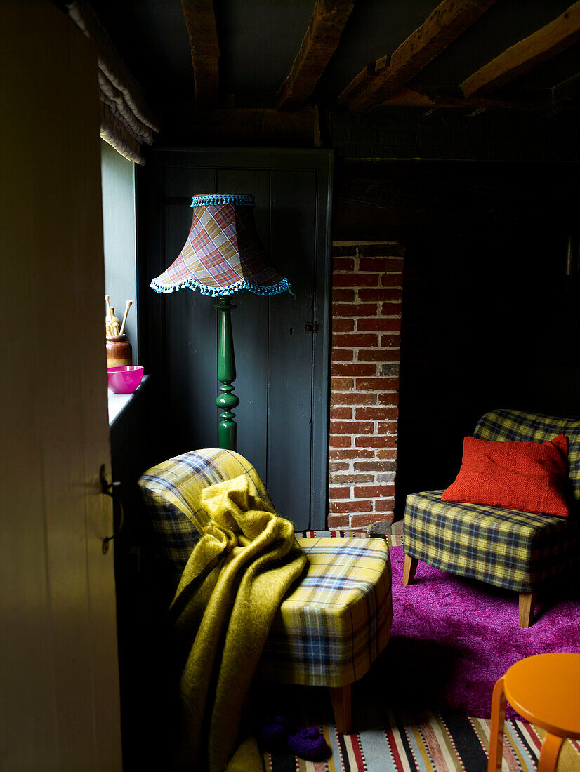 Chairs covered in tartan fabric in beamed farmhouse