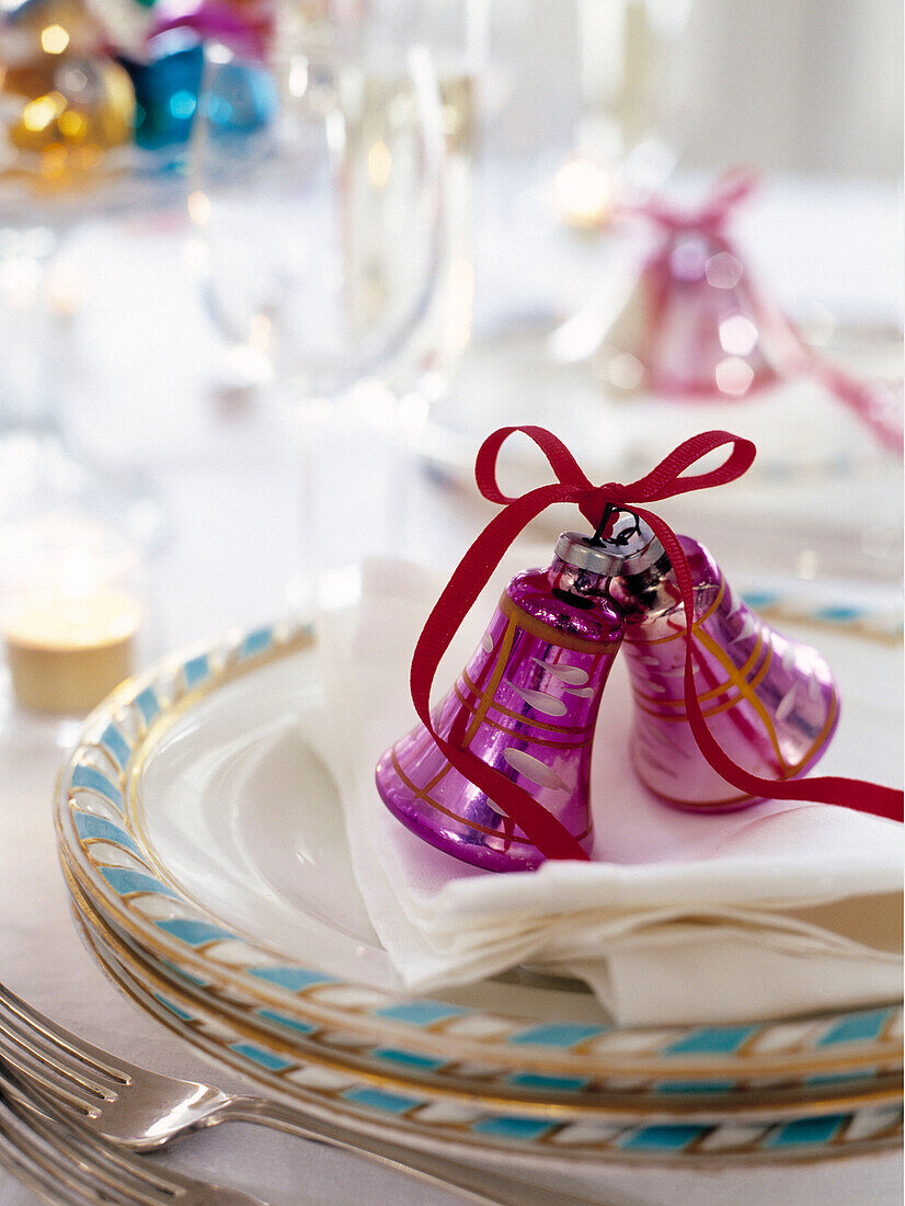 Purple Christmas bells on napkins with plates