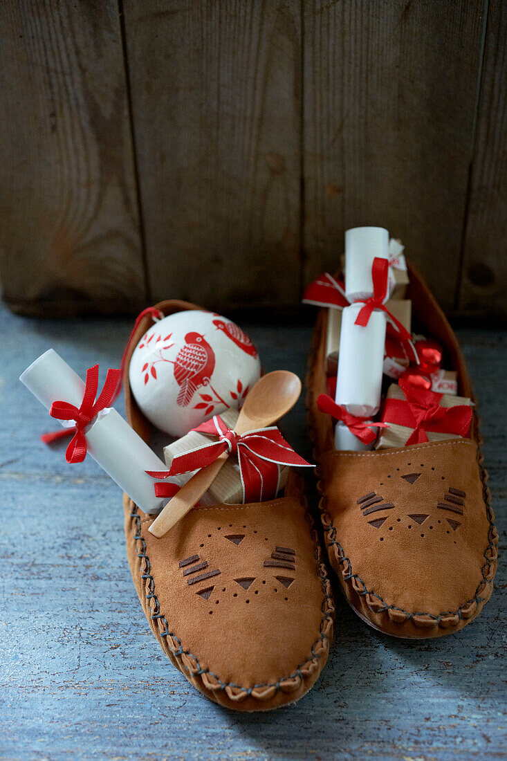Pair of leather moccasins with red and white gifts