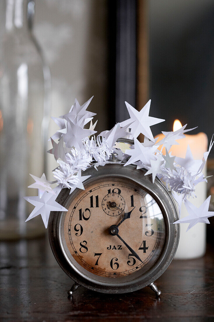 Vintage alarm clock with white star decorations