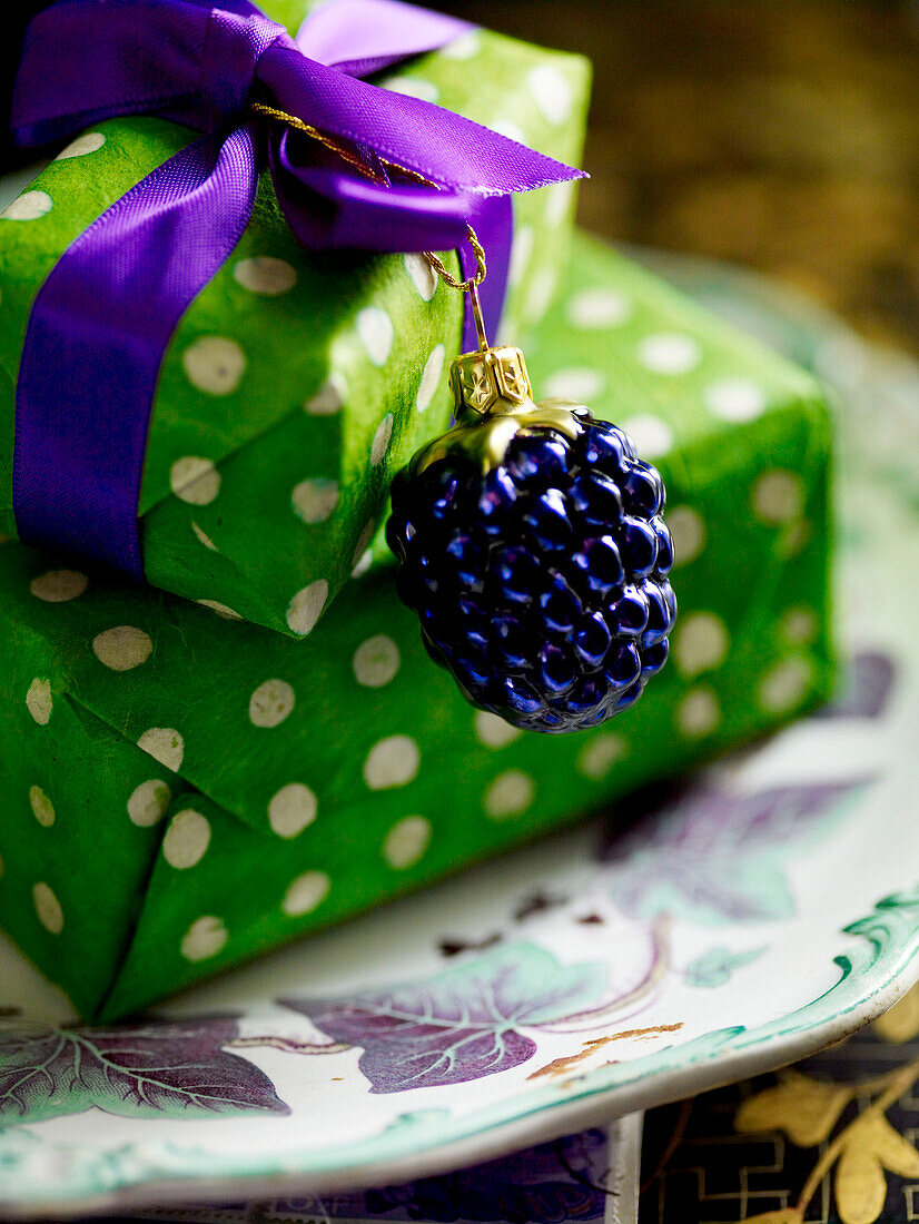 Gifts wrapped in bright green spotted paper with small bauble and ribbon