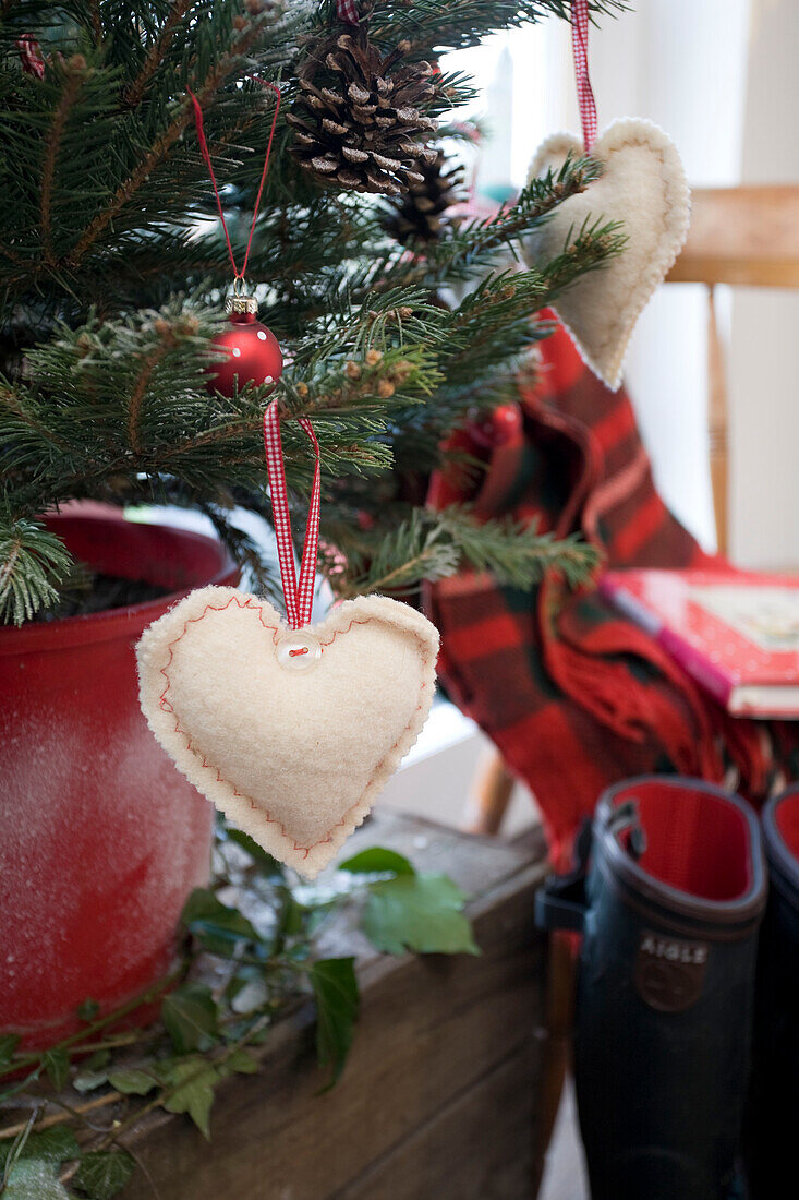 Heart shaped tree ornament and wellington boots in Tenterden home, Kent, England, UK