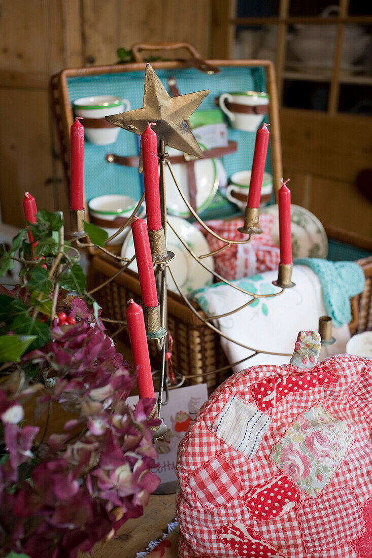 Tea cosy and candelabra with picnic hamper in Tenterden home, Kent, England, UK