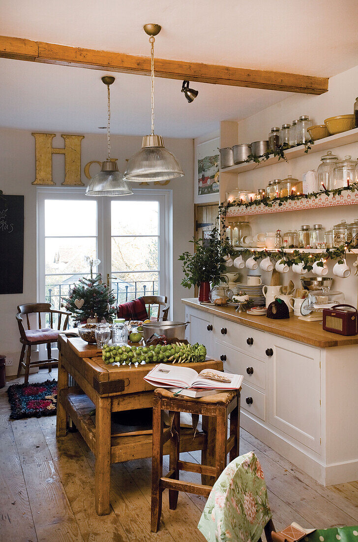 Christmas greenery in country style kitchen in Tenterden home, Kent, England, UK
