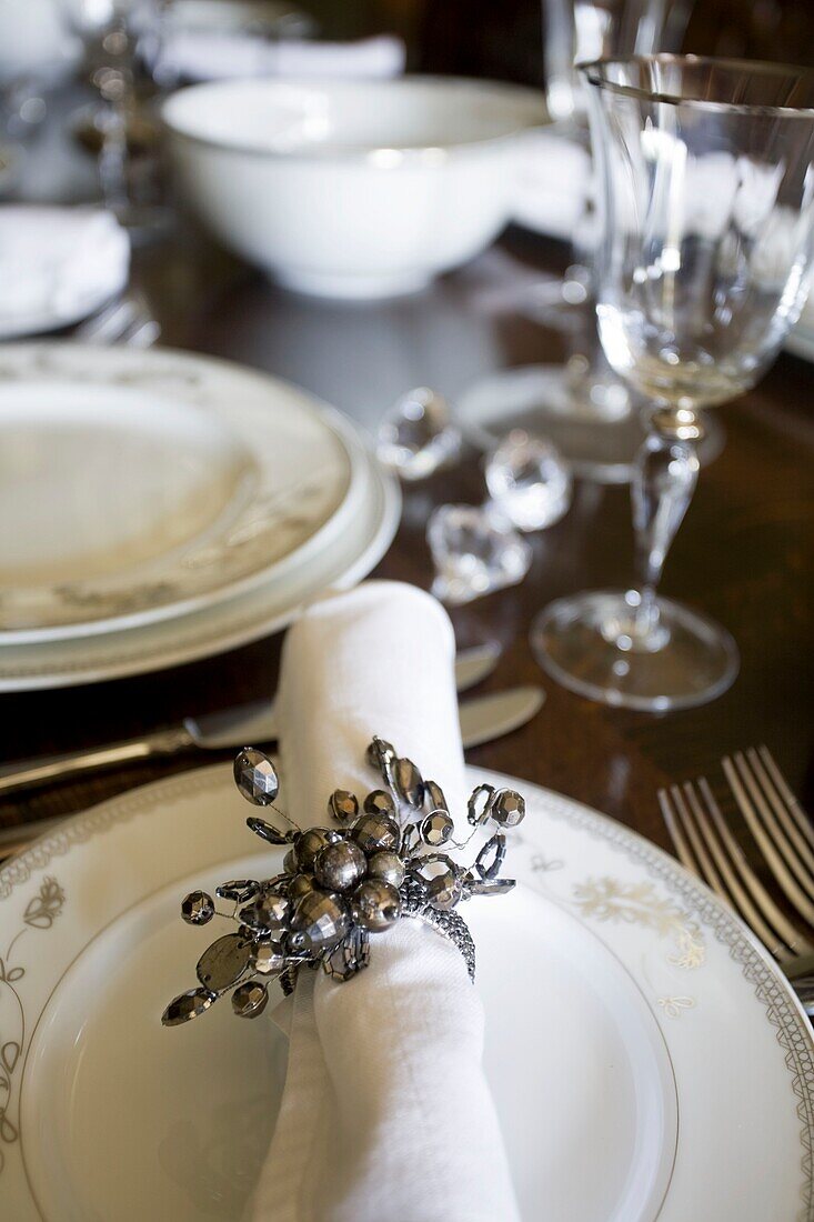 Jewelled napkin ring at place setting on dining table in Grafty Green, Kent, England, UK