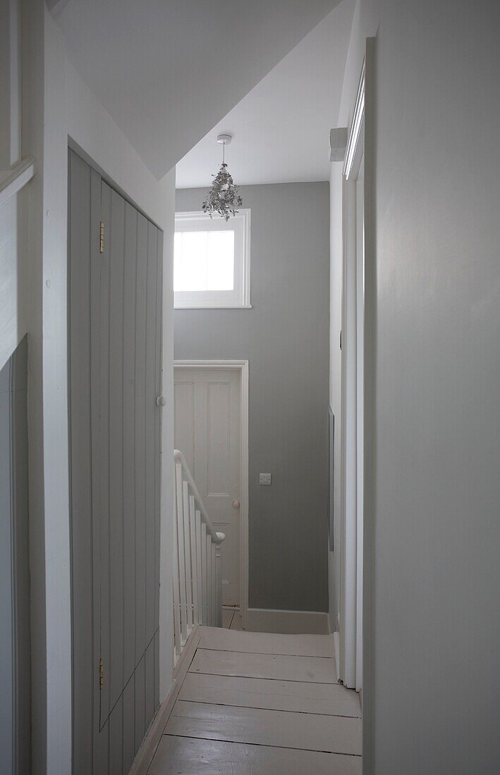 Light grey and white painted hallway in beach house, St Leonards on Sea, East Sussex, England, UK