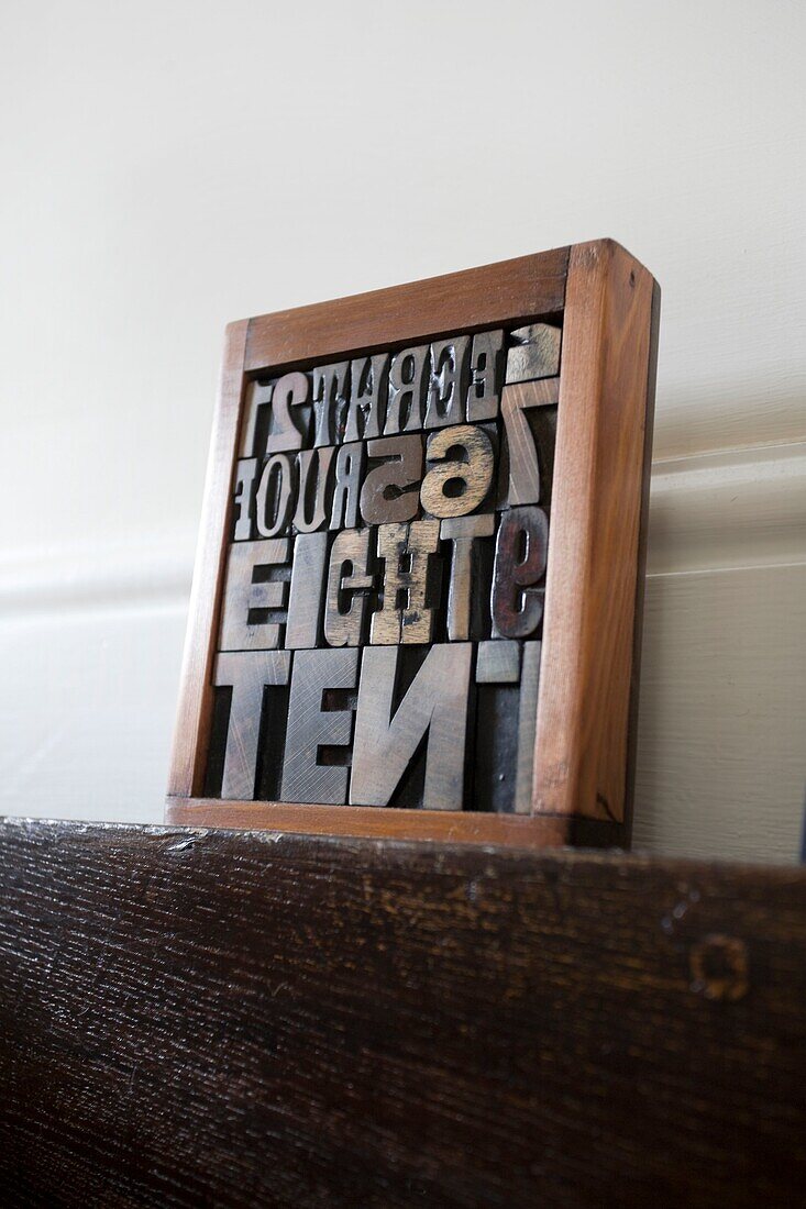 Typesetting letters in wooden frame