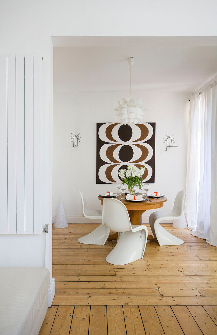 Dining table with 1960s style retro print in Manchester family home, England, UK