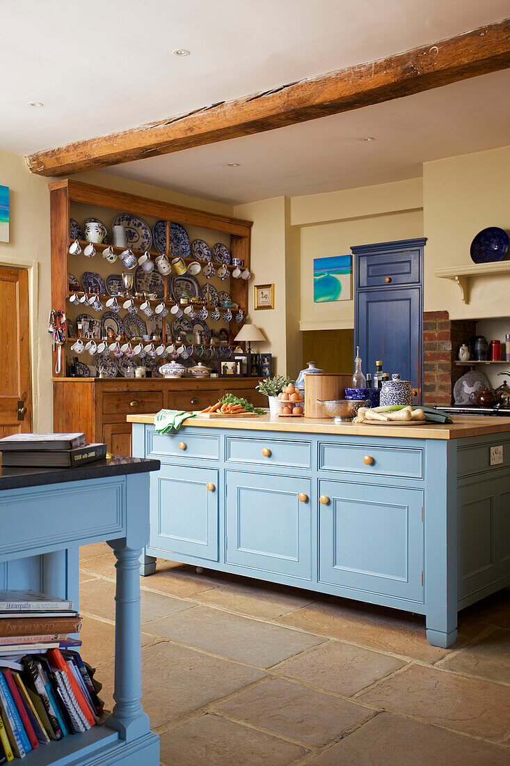 Hellblaue Kücheninsel in der Küche eines freistehenden Bauernhauses in Etchingham, East Sussex, England UK
