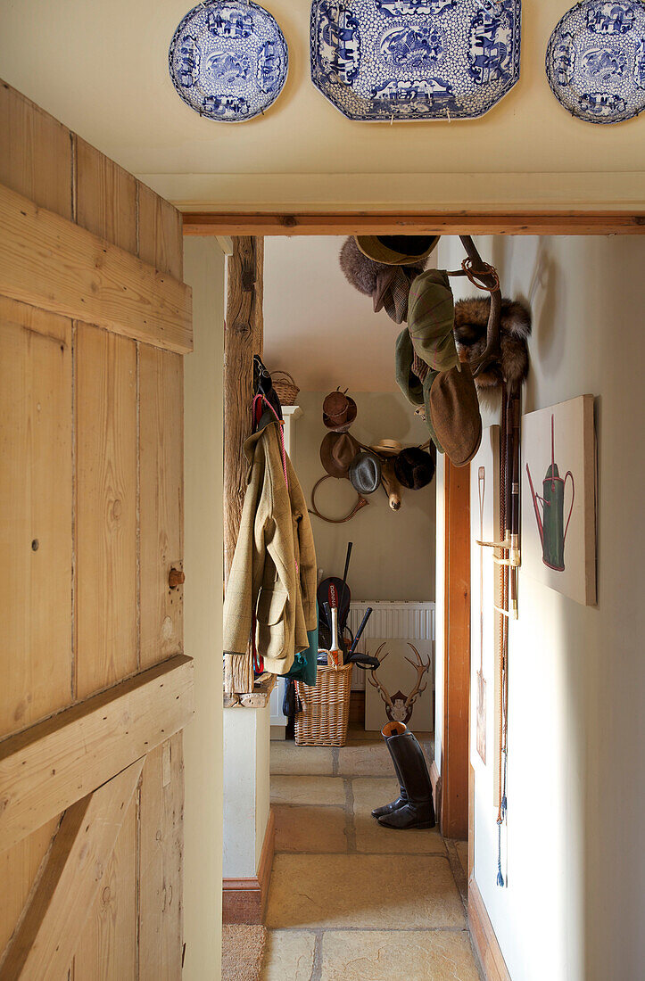 Flatcaps and coat hang in hallway of Etchingham farmhouse East Sussex England UK