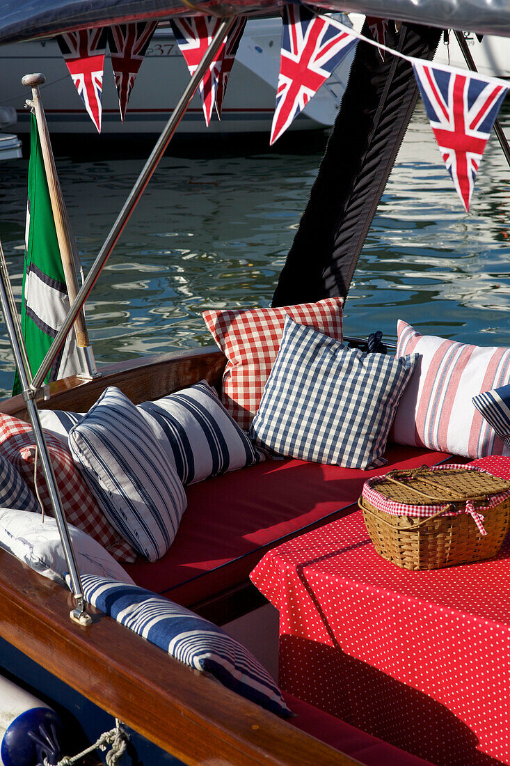 Union Jack bunting above seating area on deck of Picnic Boat Dartmouth Devon England UK