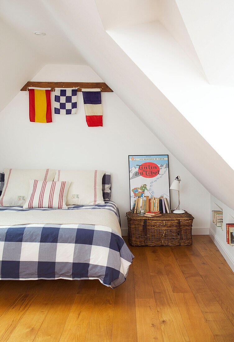 Checked duvet with flags and bedside basket in Emsworth beach house Hampshire England UK