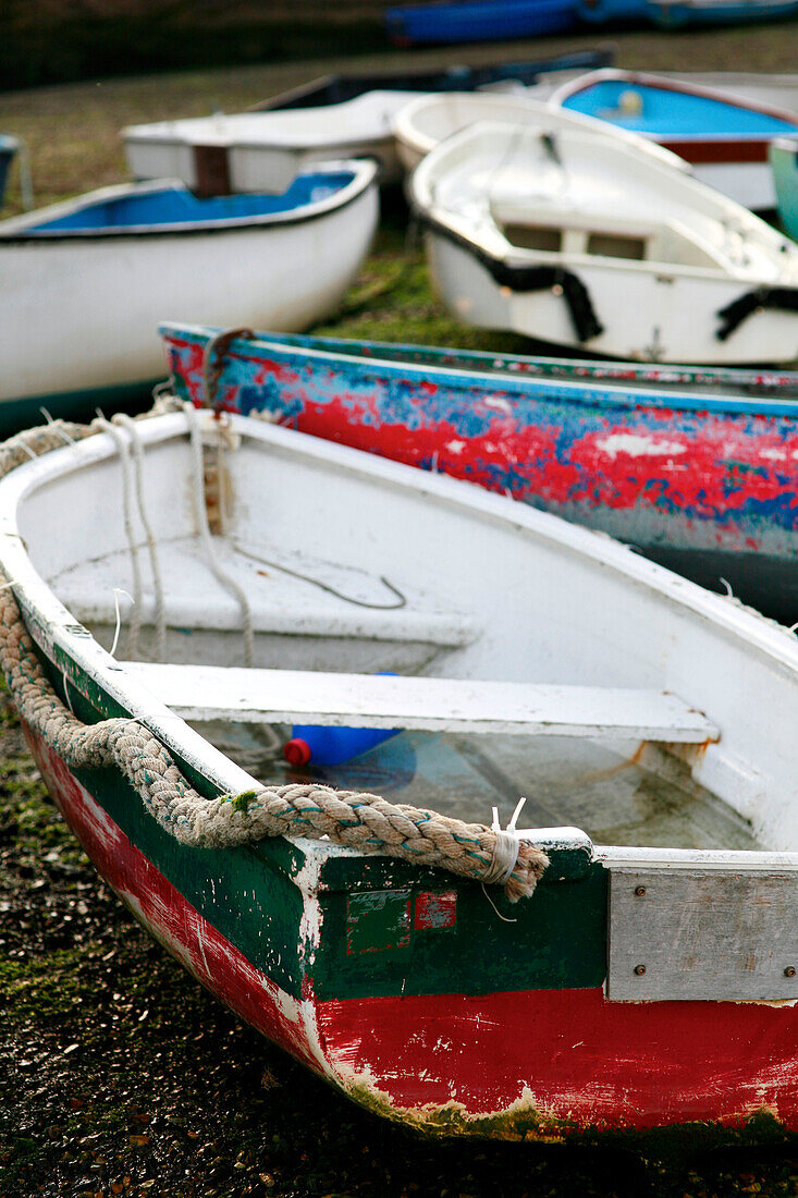 Weathered rowing boats on Emsworth beach Hampshire England UK