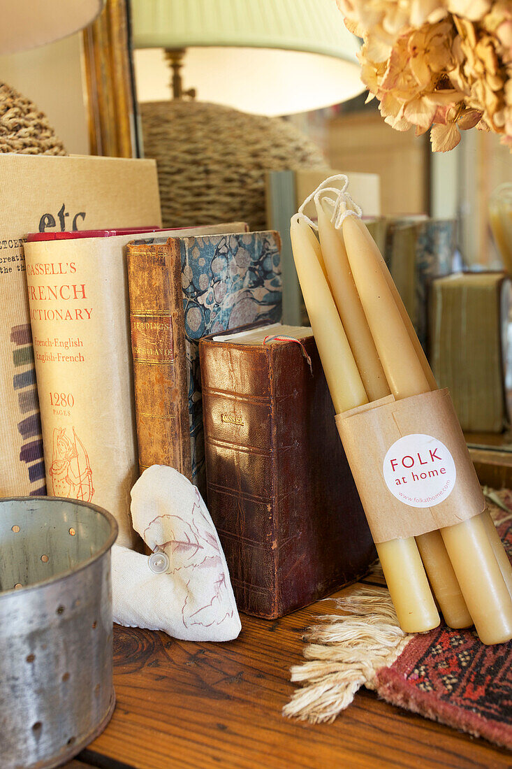 Gebundene Bücher und Kerzen mit Liebesherz auf einem Regal in einem Haus in Kent, England UK