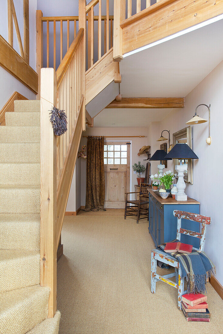 Geländer aus hellem Holz auf einer Teppichboden-Treppe in der Eingangshalle eines Bauernhauses in Kent England UK