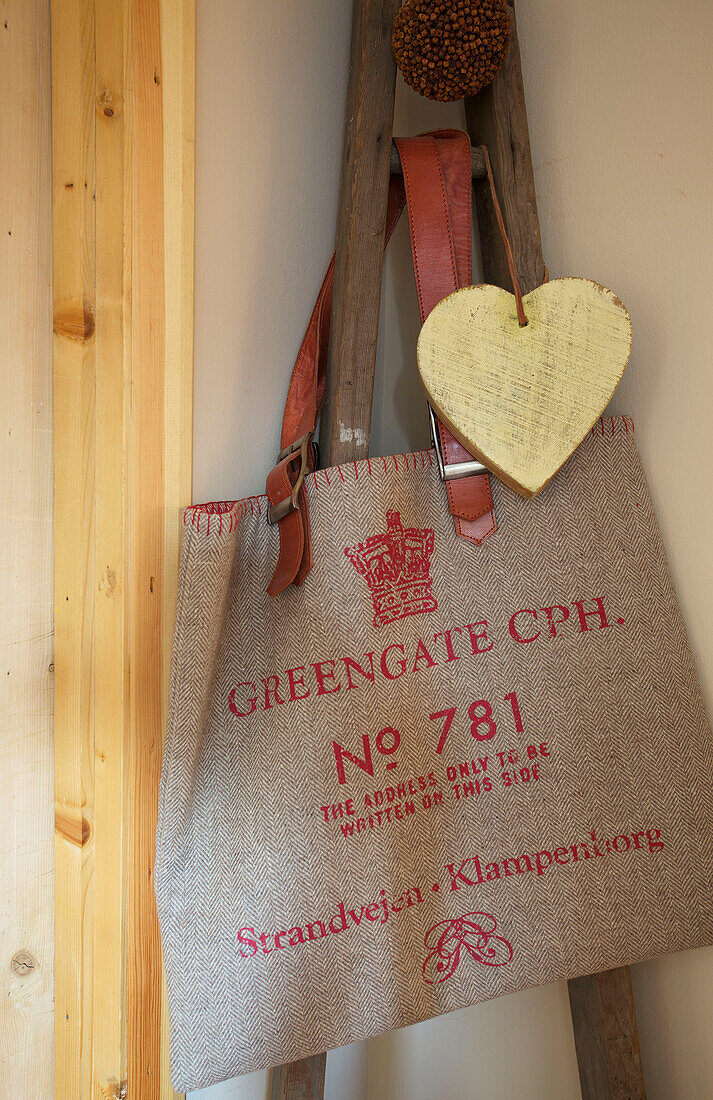 Yellow wooden heart and shopping bag in Kent farmhouse England UK