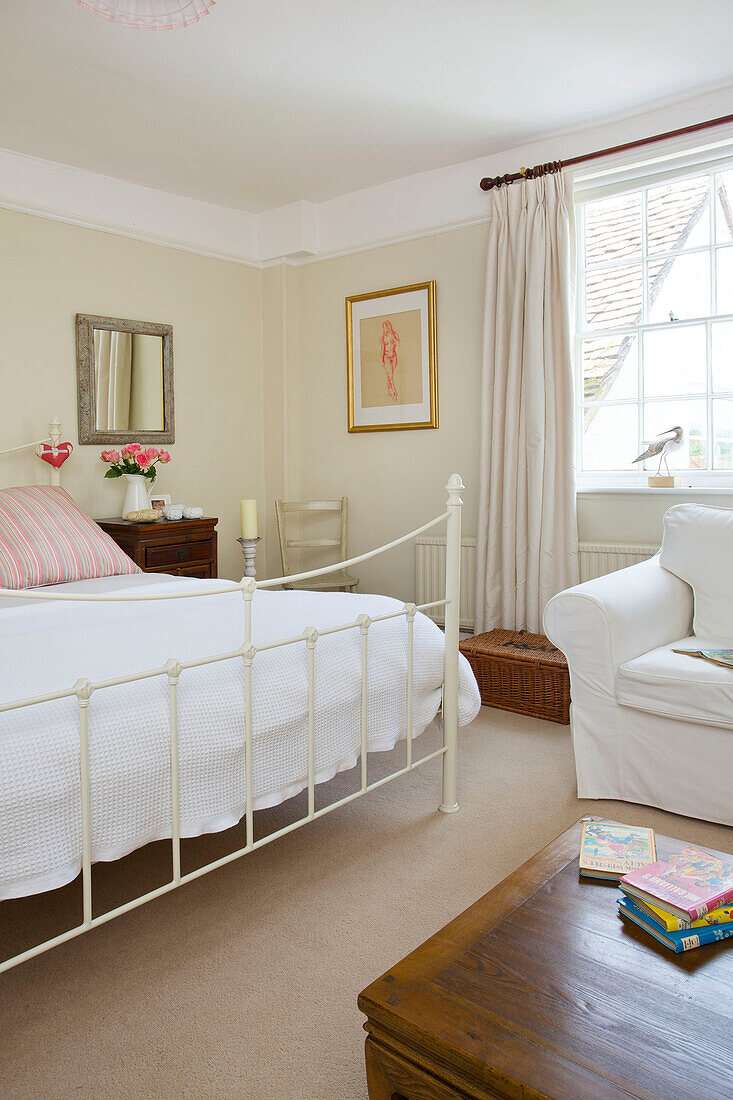 Doppelbett mit weißem Sessel und Deckenkasten in Bishops Sutton home Alresford Hampshire England UK