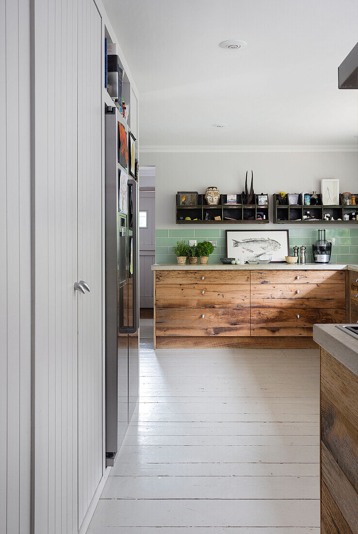 White painted floorboards with salvaged wooden drawers in Rye kitchen East Sussex UK