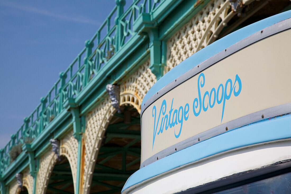 Ice cream van parked under metal promenade in Brighton Sussex England UK