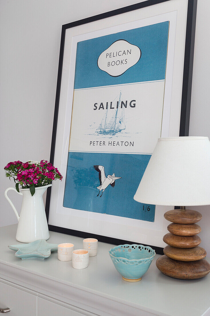 "Framed 'SAILING; book cover and lamp with flowers in Dartmouth bedroom Devon UK"""