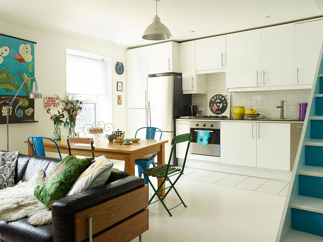 Open plan kitchen with leather sofa in London home, England, UK