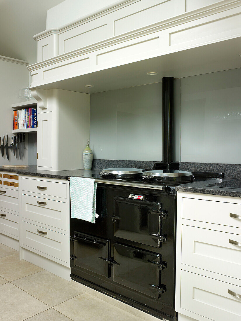 Black range oven with light green splashback in Nottinghamshire fitted kitchen England UK
