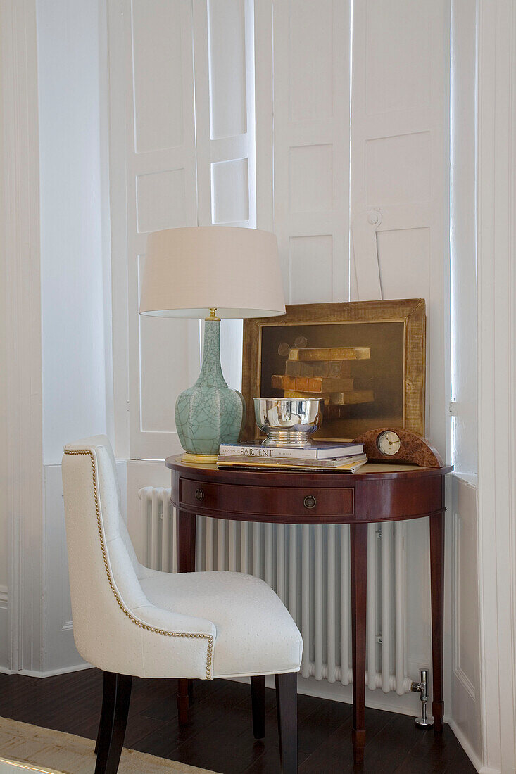 Desk and chair at shuttered window of London home UK