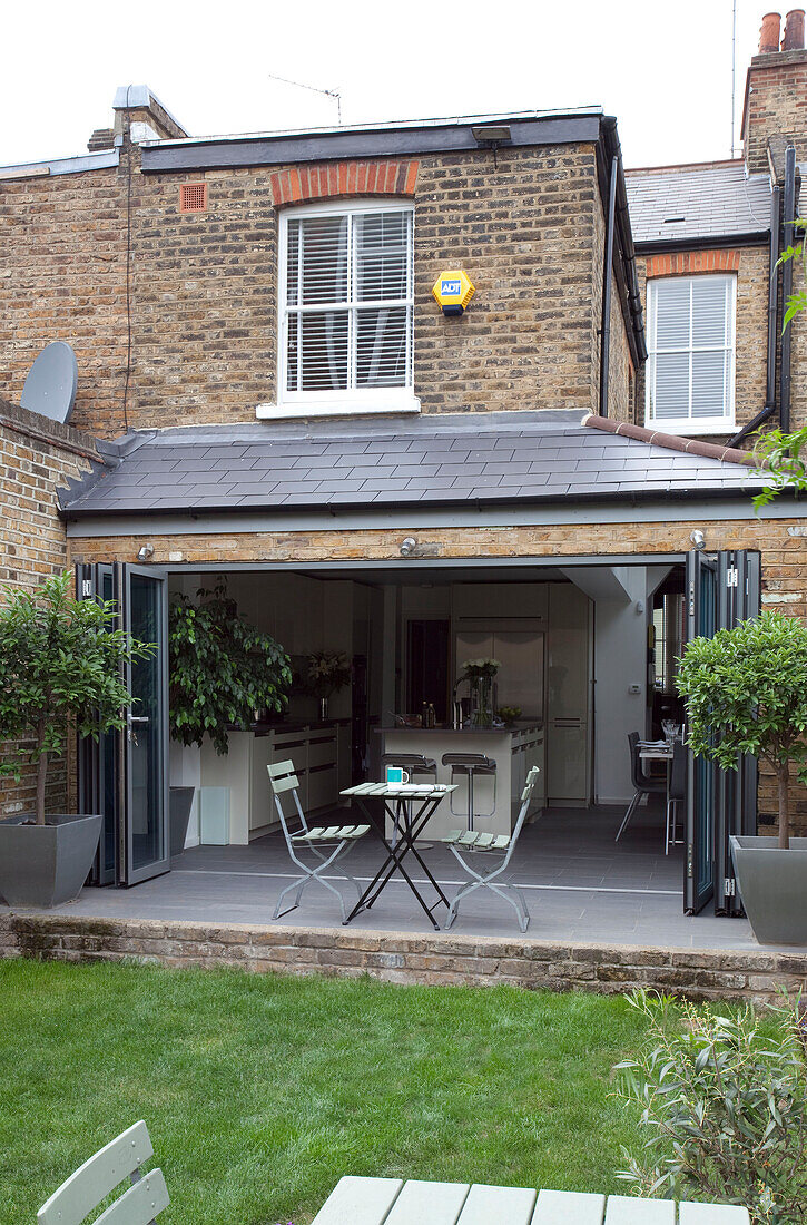 Open concertina doors to conservatory extension of London home, UK
