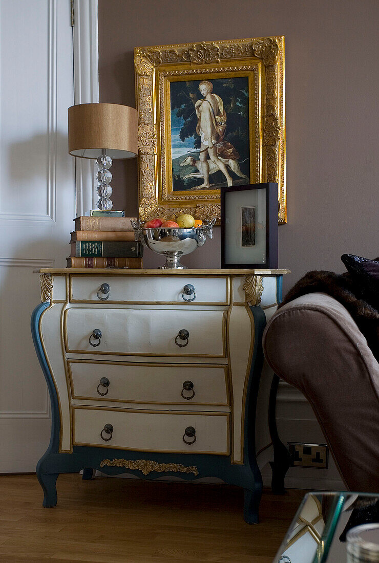 Gilt picture frame above up-cycled antique chest of drawers in Hove home East Sussex UK