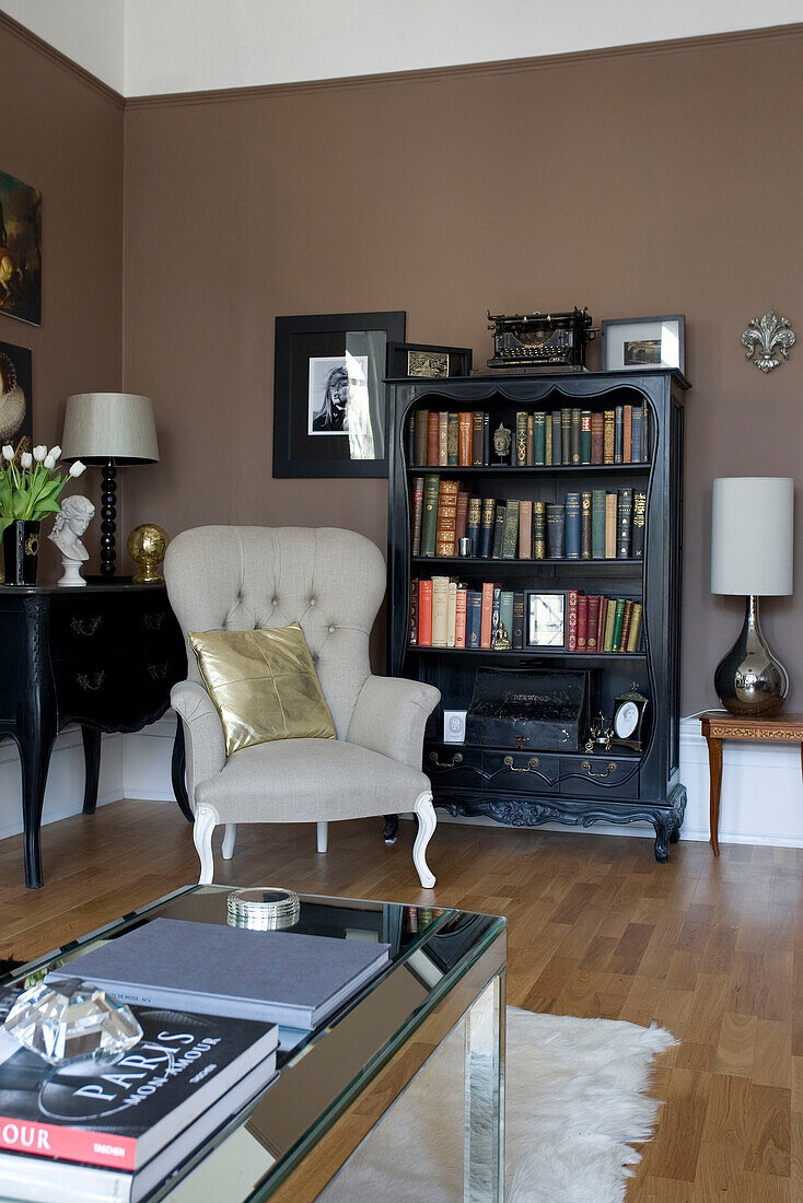 Sessel und Bücherregal in einer Wohnzimmerecke in einem Haus in Hove, East Sussex UK
