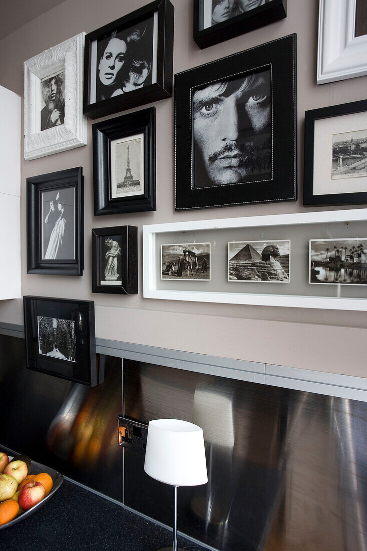 Schwarz-Weiß-Fotografien in einer Küche mit metallischer Spritzschutzwand Hove East Sussex UK