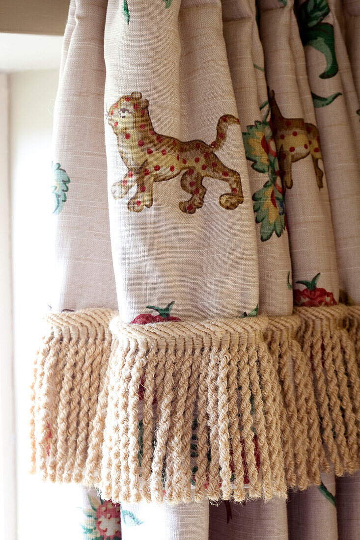 Animal print curtains with with fringing in Kent cottage, England, UK
