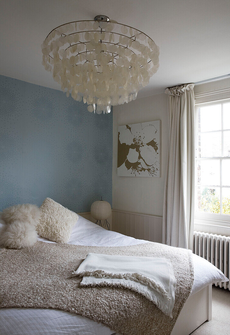 Honesty ceiling lamp in light blue bedroom of London home UK