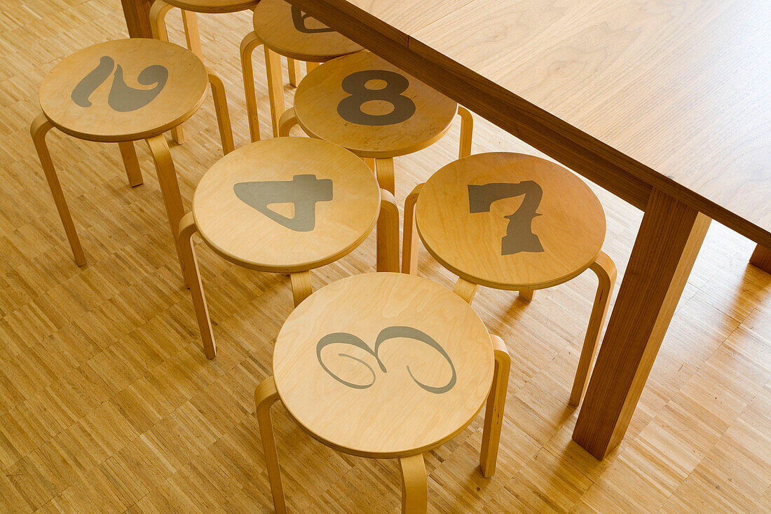 Numbered stools at table in office London UK