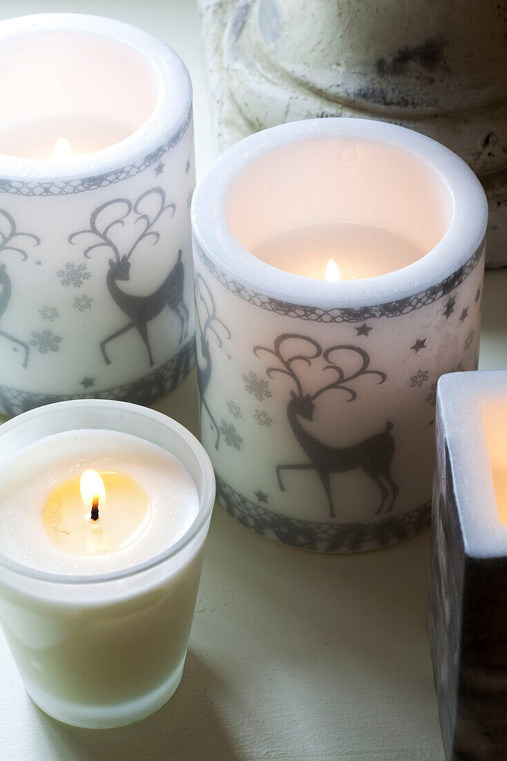 Three lit candles in Sussex home UK