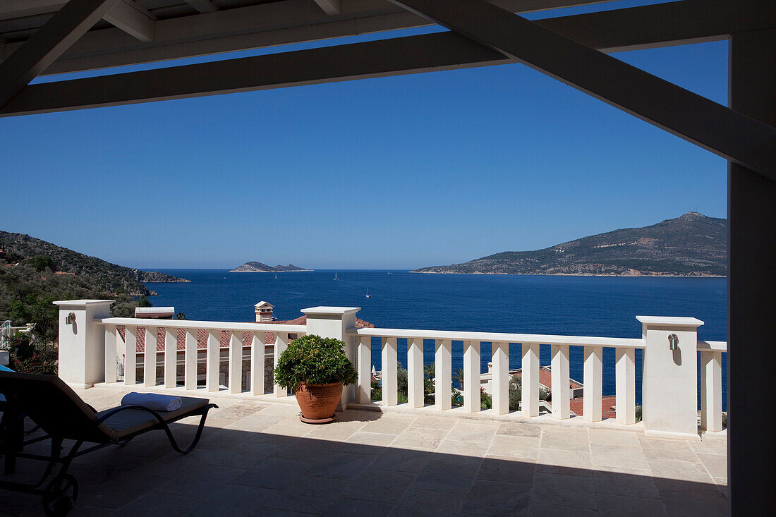 Sunlounger on shaded balcony terrace of holiday villa, Republic of Turkey
