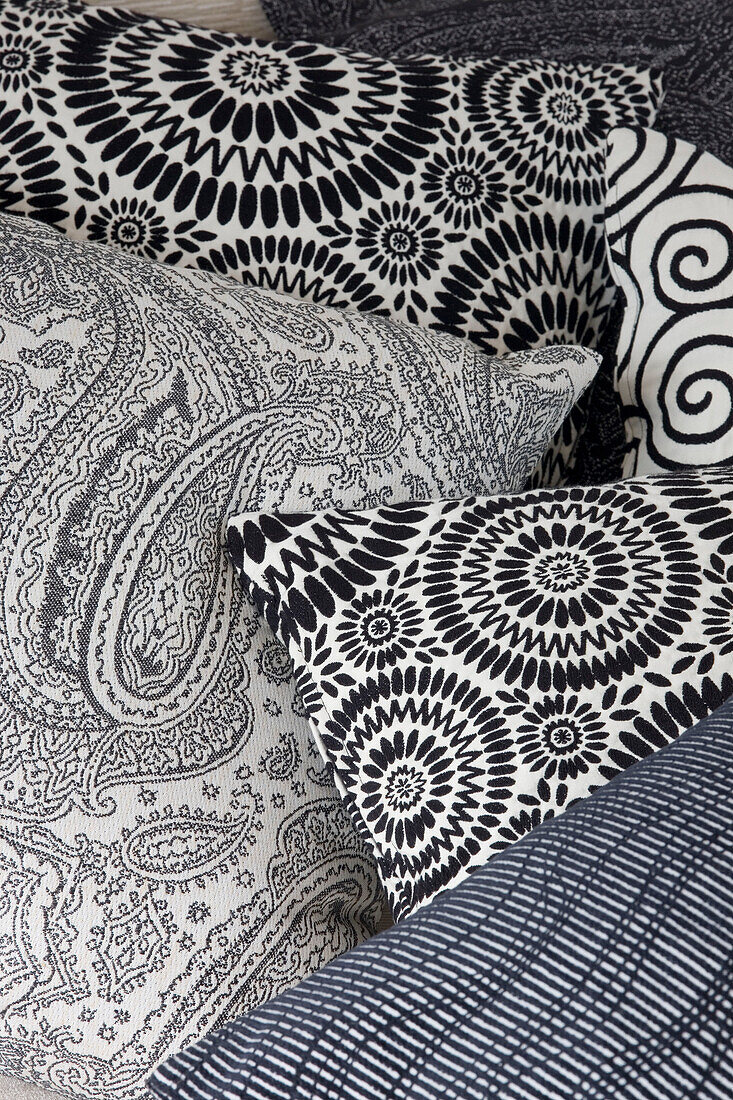 Black and white monochromatic printed cushions in London family home, England, UK