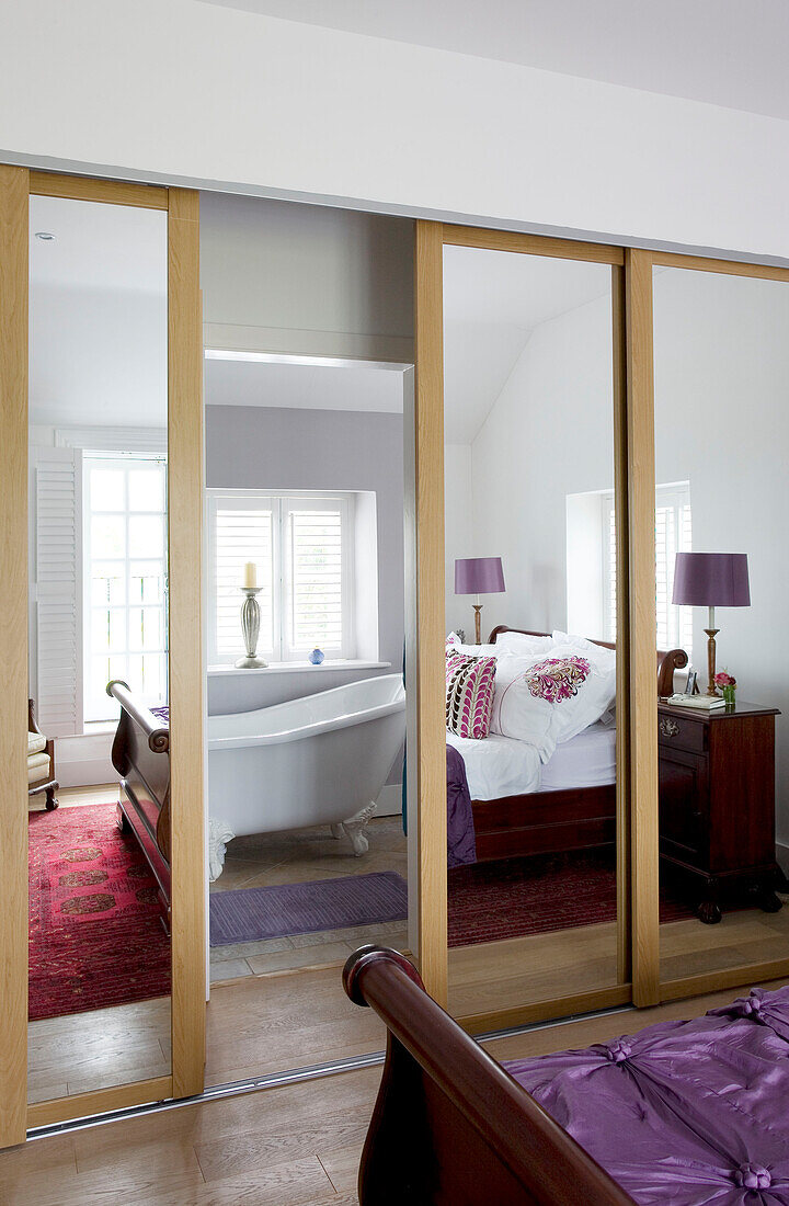 Bedroom distorted in mirrored wardrobe in Wepham home Sussex UK